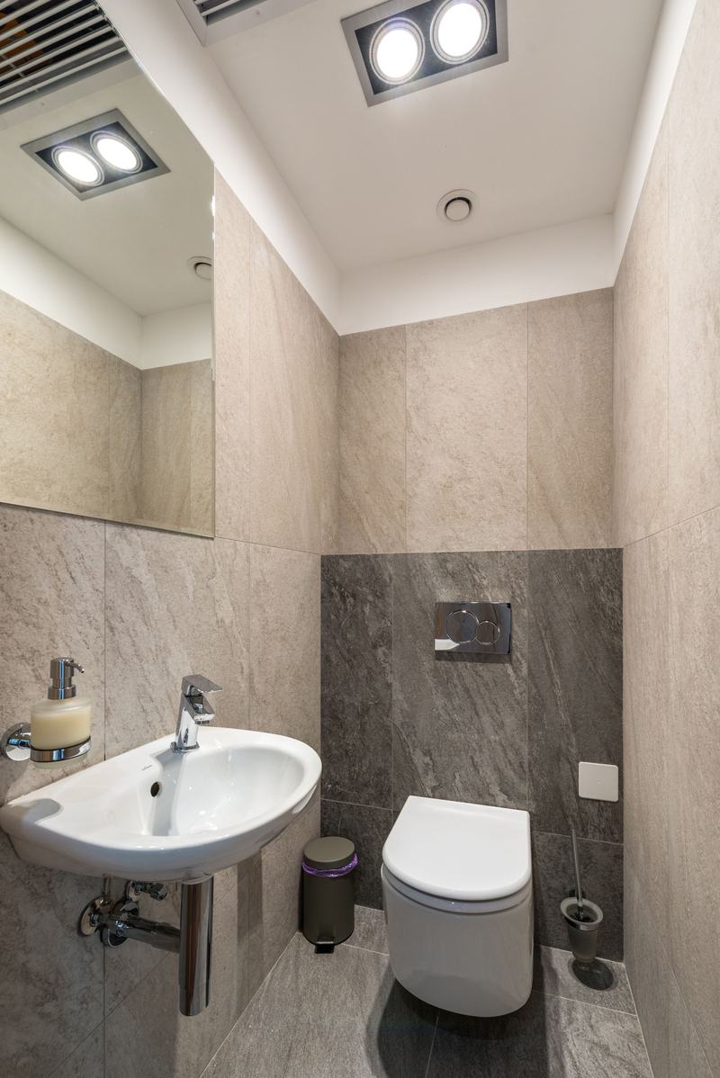 A finished small bathroom with wall-hung toilet and sink