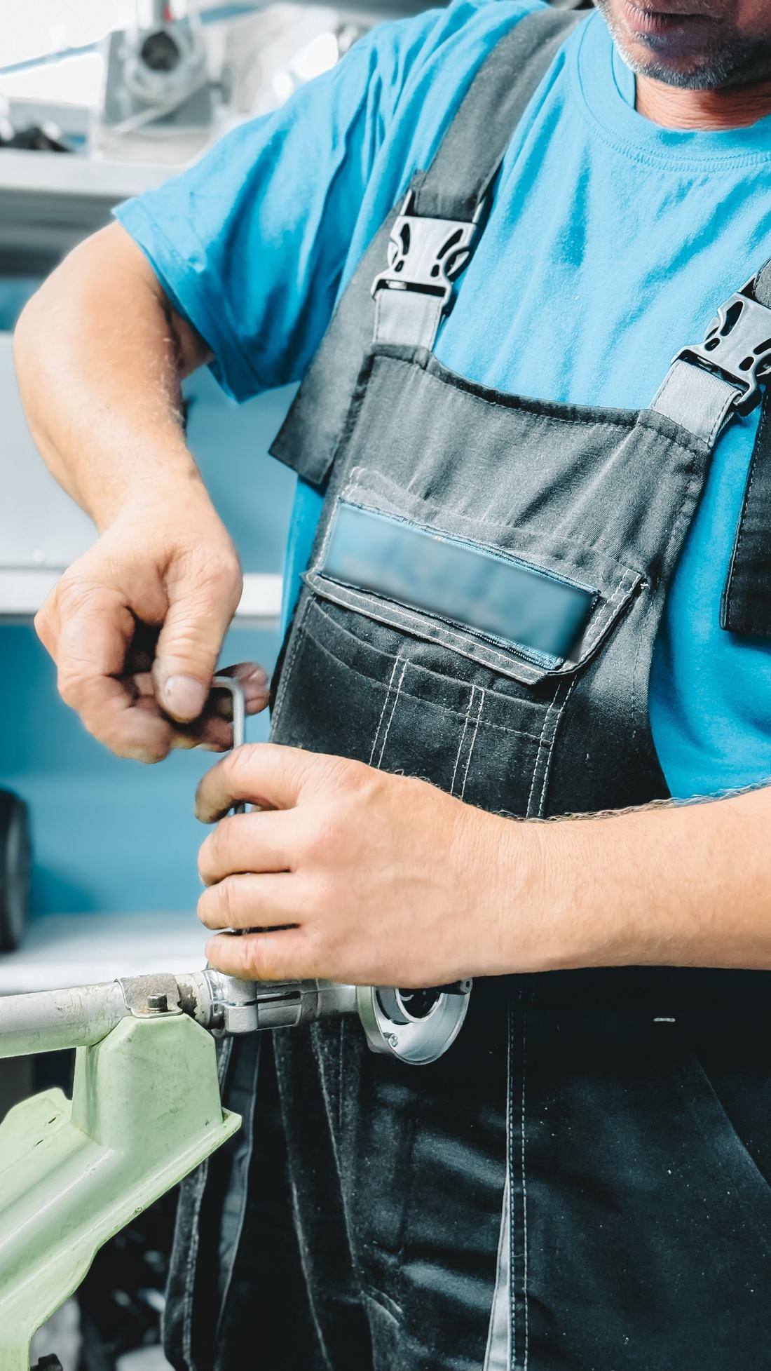 One of our plumbers tightening a fitting with a pipe wrench